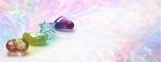 Crystal Healing web banner background template - three tumbled crystals and a merkabah against a multicoloured wispy energy field background with copy space for message or business card text
