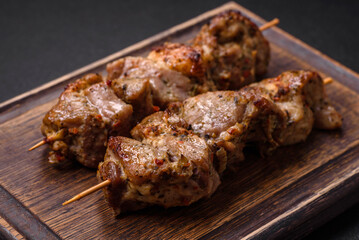 Delicious fried shish kebab of chicken or pork meat with salt, spices and herbs