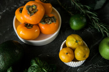 Kitchen work surface with cutting board and fresh variety of fruits on the table. Concept of healthy eating and lifestyle