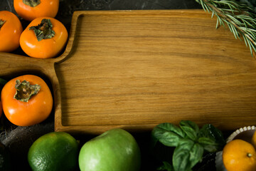 Kitchen work surface with cutting board and fresh variety of fruits on the table. Concept of healthy eating and lifestyle