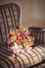 Wedding beautiful bridal bouquet of natural flowers on chair. 