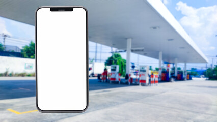 Mock up smartphone in hand closeup on the background of a gas station. Payment refueling online, smartphone with mockup blank screen blur background of twilight gas station - obrazy, fototapety, plakaty
