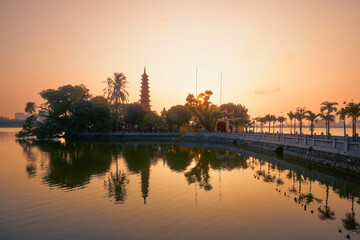 Fototapeta na wymiar West lake and water reflection of Tran Quoc Pagoda - the oldest Buddhist temple in Hanoi at twilight, Vietnam..
