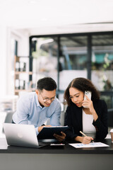 Business leading team meeting and using tablet and laptop with financial in office