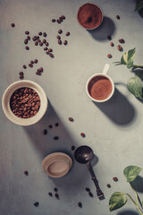 A cup of coffee and coffee beans on the table. . - 675249307