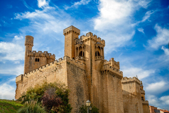 View of the medieval castle of Olite, Navarra, Spain, with its many slender towers in midday light.