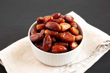 Organic Dry Deglet Nour Dates in a Bowl, side view.