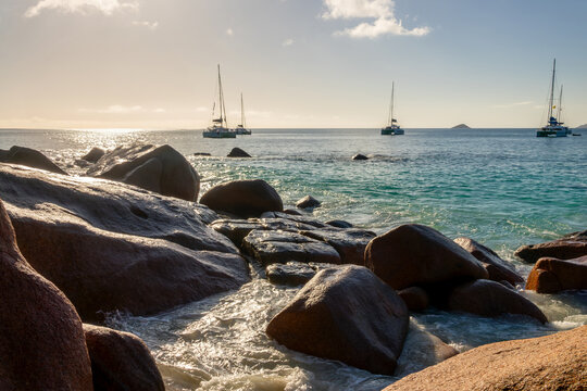 Granite rocks and sailboats at Anse Lazio, scenic beach in Praslin island, Seychelles