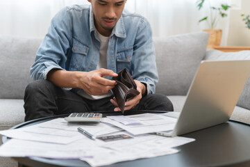 Bankruptcy problem financial concept, Young man opening empty wallet stress to find money to pay debt mortgage  period. - obrazy, fototapety, plakaty