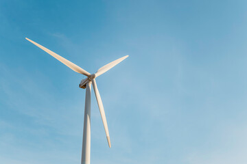 Close-up of a windmill. Blue sky in the background. Renewable energies. Environmental protection
