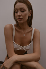 Fototapeta premium Beautiful fashion girl in lingerie with makeup, clear tanned skin, slim figure