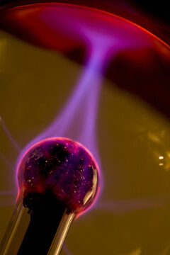 Plasma ball with red purple and pink electrical discharge

