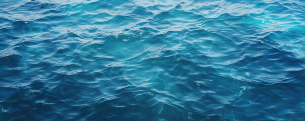 Obraz premium Blue sea water surface with sun glare and ripple background