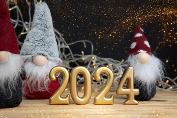 New Year, Christmas background. Candle numbers 2024 with a decorative small Christmas gnomes on a...
