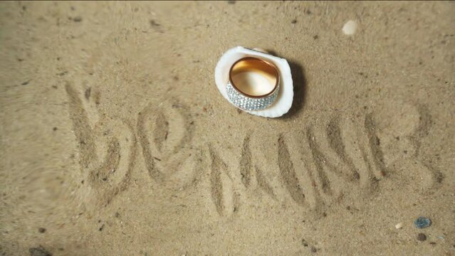 Inscription on seabed be mine, precious ring in seashell. Offer to be together.
