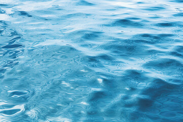 Blue sea water surface with sun glare and ripple background