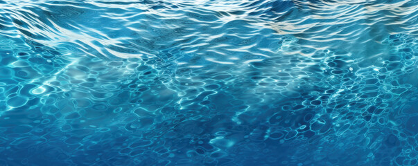 Fototapeta na wymiar Blue sea water surface with sun glare and ripple background