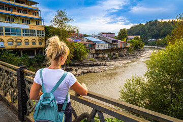 A girl enjoys the picturesque view of the Kutaisi embankment.  Georgia