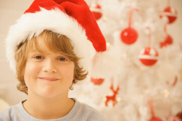 Boy wearing a red and white Christmas hat
