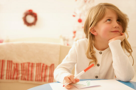 Girl writing a letter to Father Christmas
