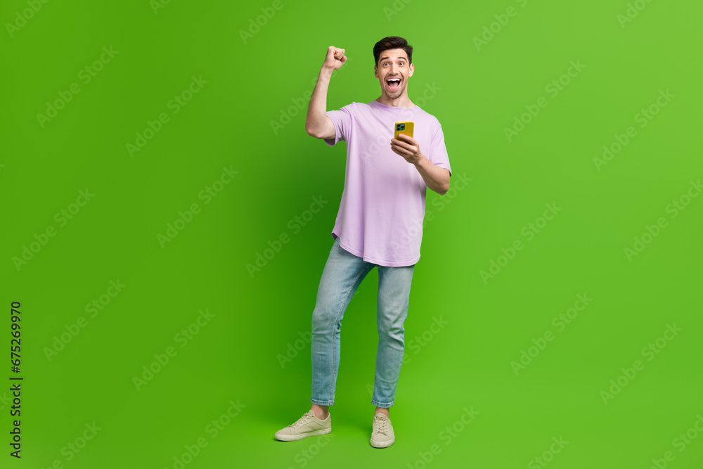 Sticker Full length photo of cheerful nice man dressed trendy clothes raise hand fist rejoice blak friday isolated on green color background