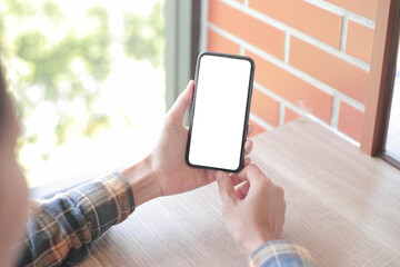 cell phone blank white screen mockup.hand holding texting using mobile on desk at office.background empty space for advertise.work people contact marketing business,technology