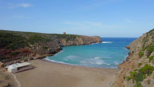 Flying over the beautiful beach of the Sardinia island Cala Domestica and seeing its famous tower on the horizon.