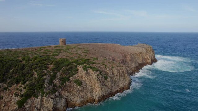 Flying towards the famous Torre di Cala Domestica on the island of Sardinia on a day with beautiful colors.
