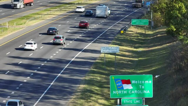 Welcome to North Carolina state line. Aerial shot of a welcome sign along interstate highway in Mecklenburg County, NC.