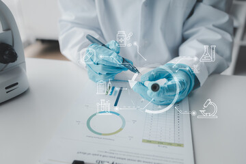 Chemist taking notes on research data, Scientist is working in the laboratory, Chemist is analyzing...