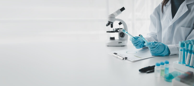 Chemist is chemically analyzing test tubes, Scientist is experimenting with chemicals in the laboratory, Chemist is separating compounds in test tubes with chemical reagents.