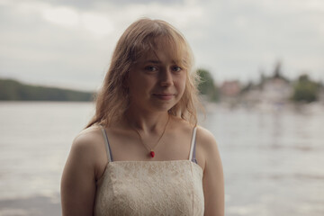 young shy cosplay woman  in dress on an rainy day on sea