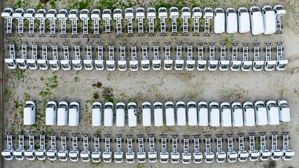 Aerial zenithal view of a group of parked white trucks and tractor-trailers