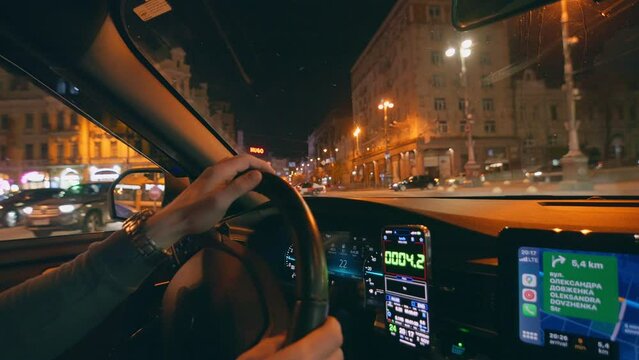 Drive night taxi street road man hand smartphone car town city