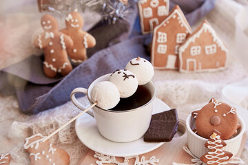 Winter aesthetic table settings. Marshmallow snowman in hot cocoa and ginger cookies with Christmas...