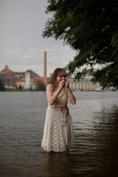 young shy cosplay woman  in dress on an rainy day on sea