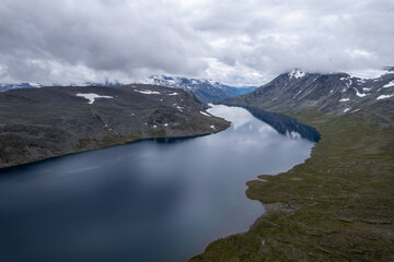 Aerial view above Jotunheimen Norway - Glacier fed lakes in the highlands and valleys of Central Norway	