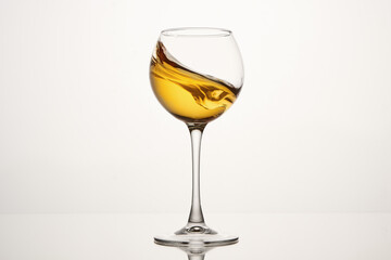 White wine diagonal wave, curl is in stemmed glass.