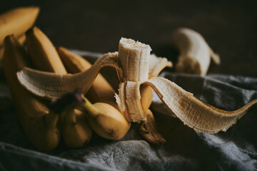 Close-up of a bunch of bananas on a dark fabric background