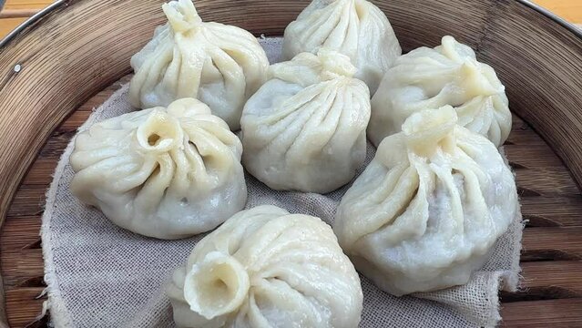 Hot meat dumplings close up in bamboo steamer