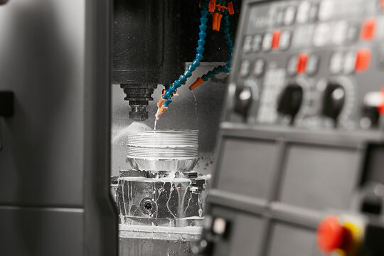 Auto CNC turning with robot drill milling factory with water coolant streams. The mold and die manufacturing process by CNC machining center.