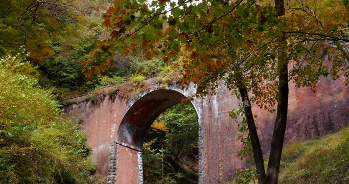 A view of a brick arch bridge at the site of an abandoned railway line.