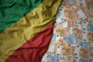 colorful waving national flag of republic of the congo on a euro money background. finance concept