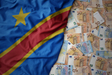 colorful waving national flag of democratic republic of the congo on a euro money background. finance concept