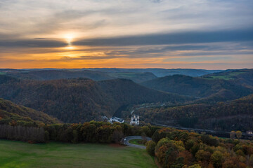 Fototapeta premium Bird's-eye view of the Arnstein Monastery near Oberhnhof/Germany on the Lahn at sunset