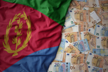 colorful waving national flag of eritrea on a euro money background. finance concept