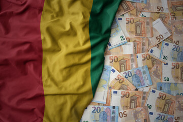 colorful waving national flag of guinea on a euro money background. finance concept
