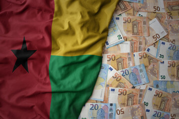 colorful waving national flag of guinea bissau on a euro money background. finance concept