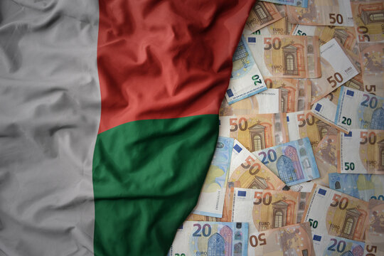 colorful waving national flag of madagascar on a euro money background. finance concept