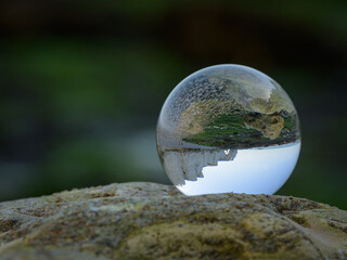 Chalk cliffs of Etretat seen through glass sphere